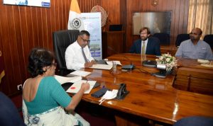 The signing of the Progression Agreement by the Vice-Chancellor and Registrar